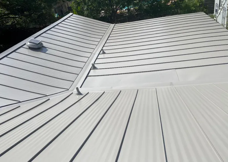 Solar attic fan installed on a metal roof for Roof Ventilation in Maysville